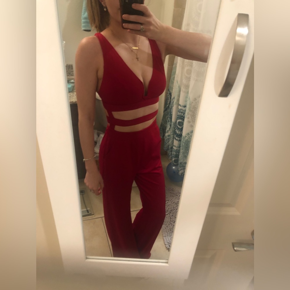 Size 8 red jumsuit with cut outs perfect for spring break or Miami